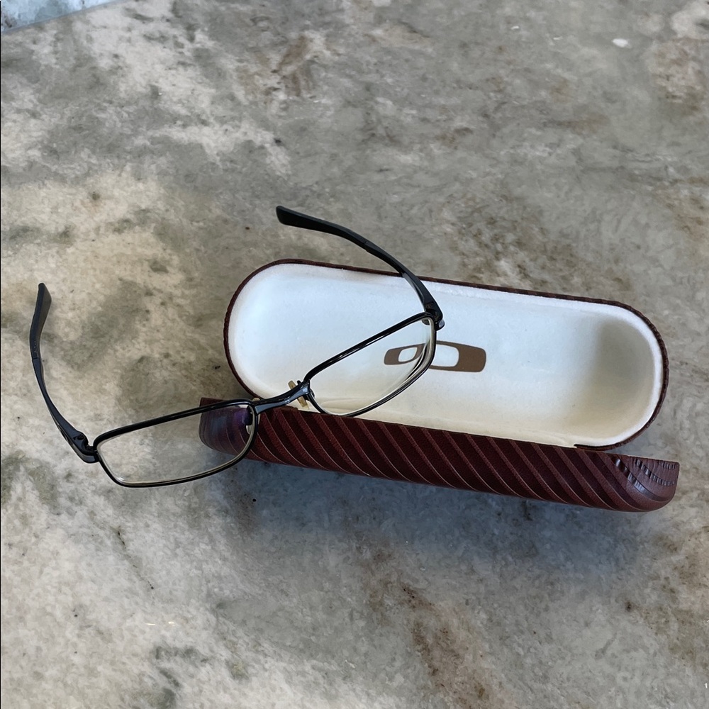 Oakley black/grey metal frames. Includes hard carrying case and cloth bag.